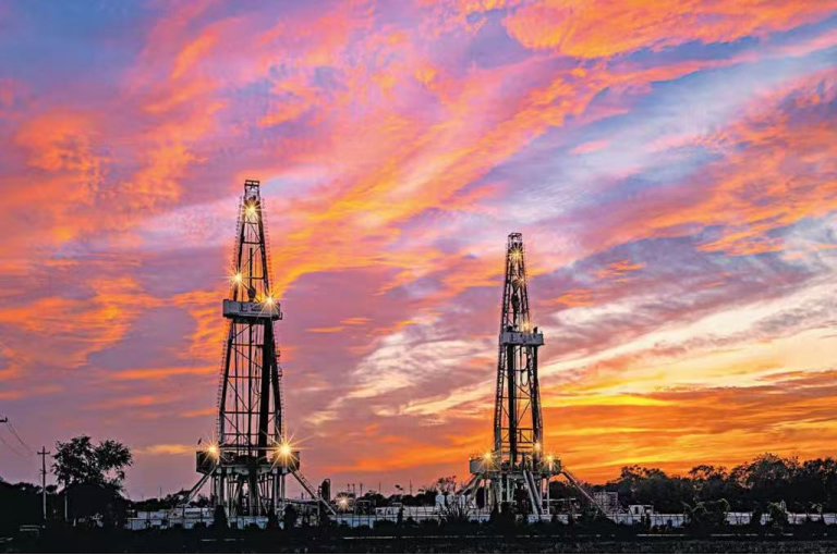 Drilling rigs at dusk